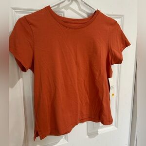 NWT woman’s short sleeve t-shirt. Size XS. Color is a burnt orange.